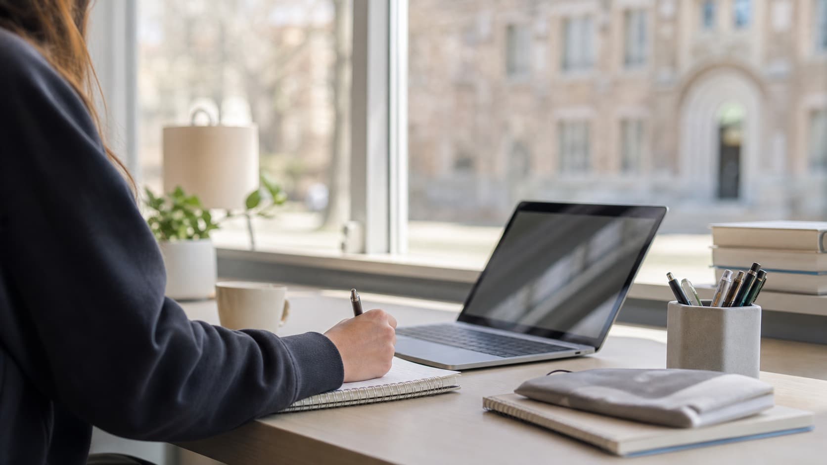 A quiet study desk with a laptop and notebook